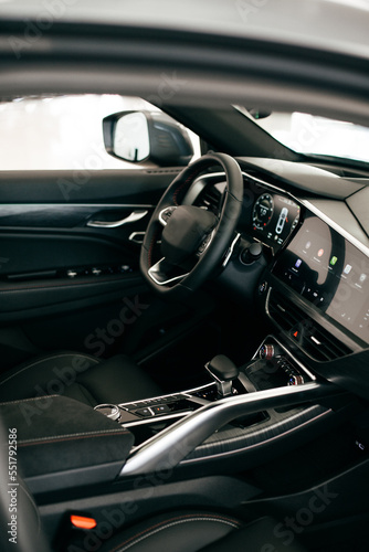Dark luxury car Interior - steering wheel, shift lever and dashboard. Car interior luxury