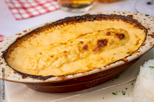 Quenelle, speciality of Lyon, oval-shaped dumplings filled with pike white fish served in creamy sauce in traditional Lyonnaise Bouchon, France