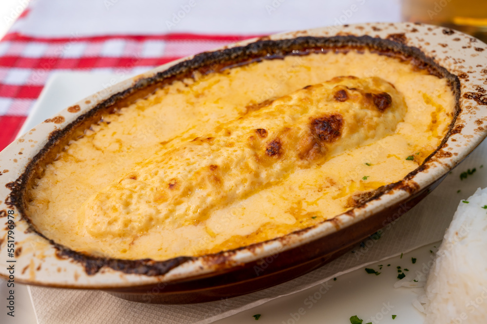 Quenelle, speciality of Lyon, oval-shaped dumplings filled with pike white fish served in creamy sauce in traditional Lyonnaise Bouchon, France Quenelle, speciality of Lyon, oval-shaped dumplings filled with pike white fish served in creamy sauce in traditional Lyonnaise Bouchon, France