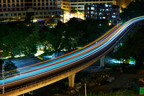 Photography Light rail transit train moving through the city in the night