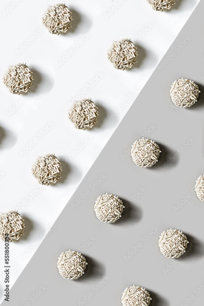 Flat lay photo of the cat litter put in the geometric pattern on the white-gray background. Flat lay photo of the cat litter put in the geometric pattern on the white-gray background.