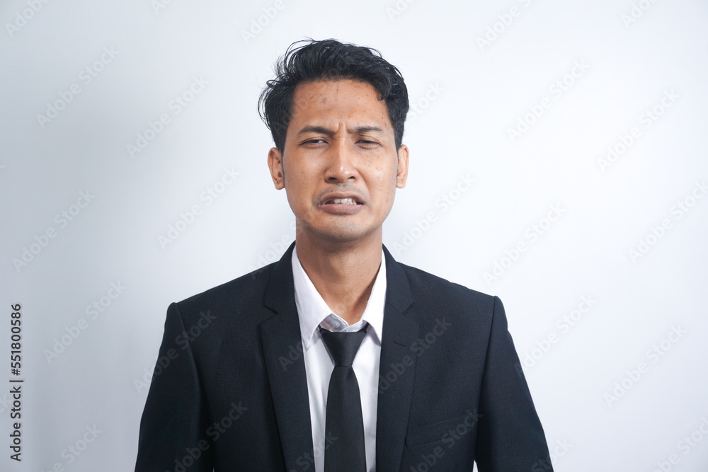 Close-up of miserable man in suit, crying and sobbing, feeling sad, standing against white background Close-up of miserable man in suit, crying and sobbing, feeling sad, standing against white background