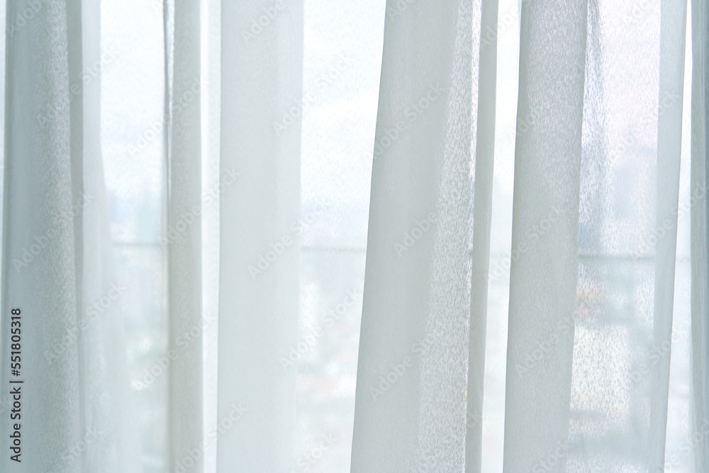 Semi-transparent tulle on the window close up Semi-transparent tulle on the window close up
