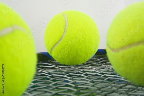 Tennis ball on a tennis racquet in macro view © enriscapes