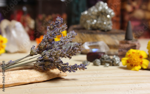 Dried Lavender on Palo Santo Sticks With Crystals and Flowers in Background