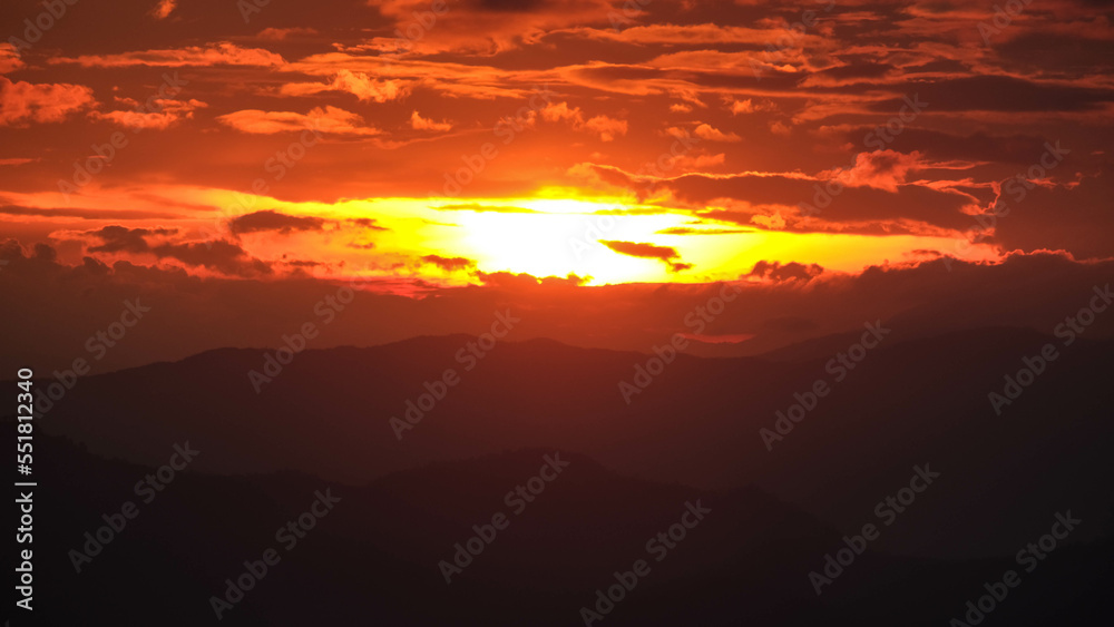 Time lapse of the beautiful sunset scenery on the top of the mountain. Aerial view of beautiful tropical valley silhouettes with the last rays of the sun. Dramatic sundown landscape.