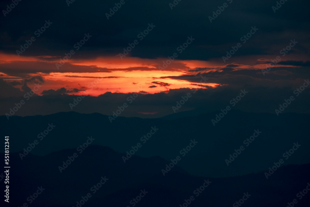 Time lapse of the beautiful sunset scenery on the top of the mountain. Aerial view of beautiful tropical valley silhouettes with the last rays of the sun. Dramatic sundown landscape.