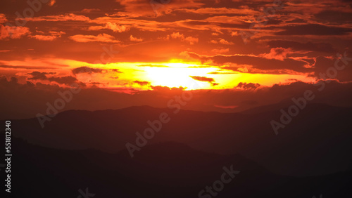 Time lapse of the beautiful sunset scenery on the top of the mountain. Aerial view of beautiful tropical valley silhouettes with the last rays of the sun. Dramatic sundown landscape. © scentrio