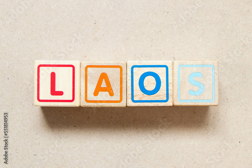 Color letter block in word laos on wood background