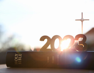 2023 new year rising sun and sunrise and cross of jesus christ and holy bible
