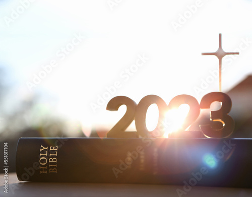Obraz na płótnie 2023 new year rising sun and sunrise and cross of jesus christ and holy bible