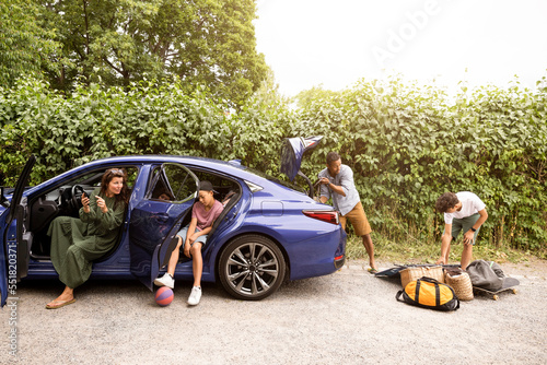Family talking with each other while preparing for vacation photo