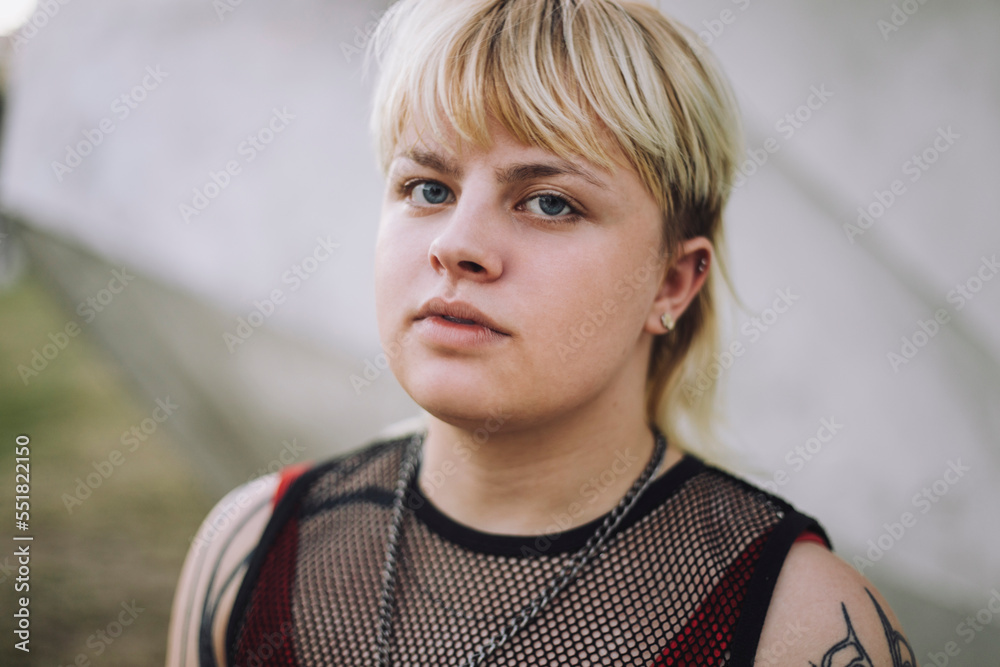 Portrait of happy young non-binary person with short blond hair Portrait of happy young non-binary person with short blond hair