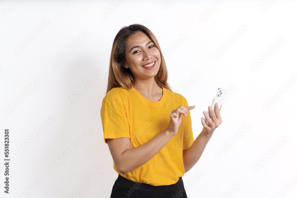 Hot asian pretty young woman smiling isolated on white, yellow t-shirt, using cellphone Hot asian pretty young woman smiling isolated on white, yellow t-shirt, using cellphone