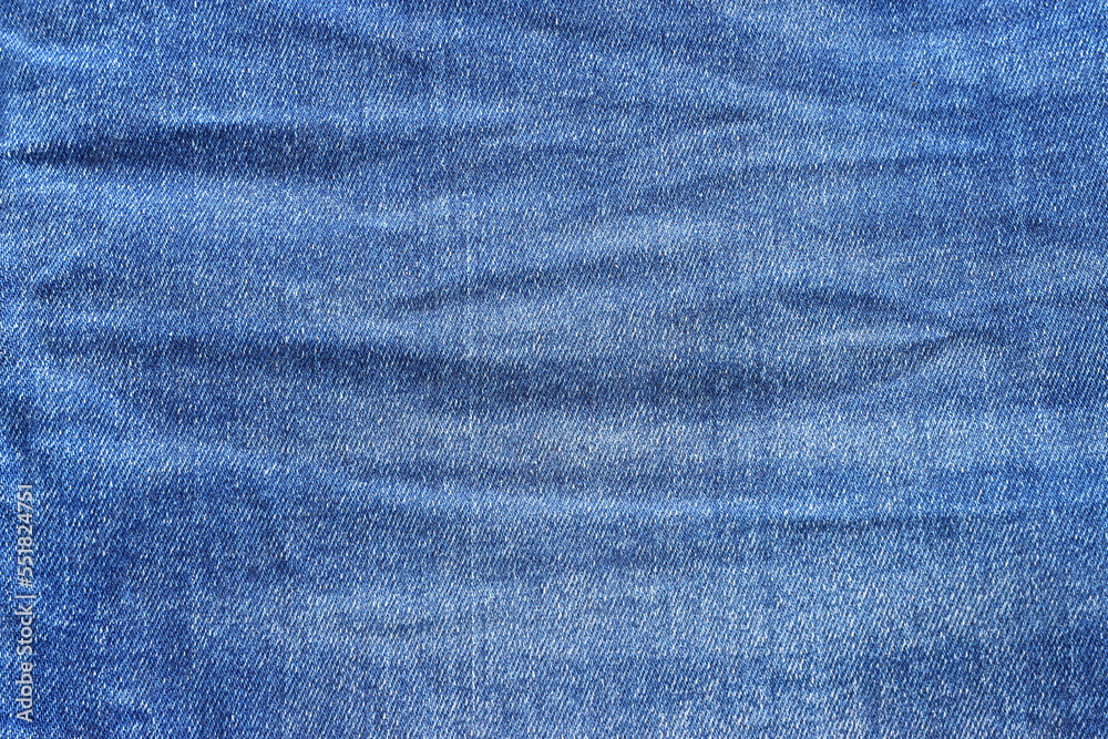close up of worn blue jeans cloth fabric close up of worn blue jeans cloth fabric