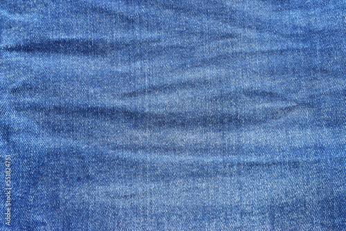 close up of worn blue jeans cloth fabric © tomertu