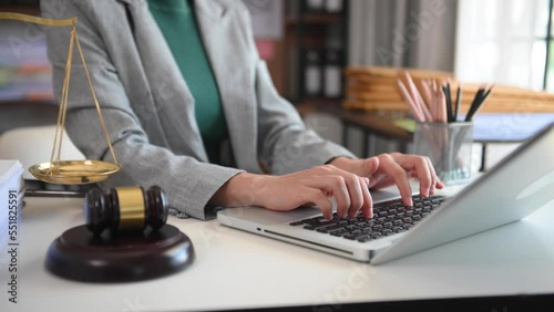 justice and law concept.Male judge in a courtroom  the gavel, working with smart phone and laptop and digital tablet computer on wood table