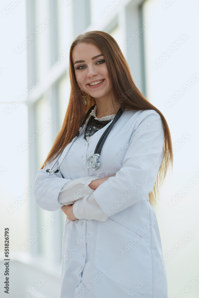 female doctor with clipboard standing in the lobby of the hospital. female doctor with clipboard standing in the lobby of the hospital.