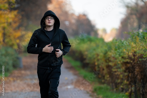 Runner in autumn park. photo