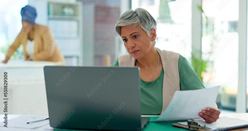 Laptop, documents and report with a business woman at work in her office for design or creative thinking. Computer, data and paperwork with a senior female employee working on a report or review