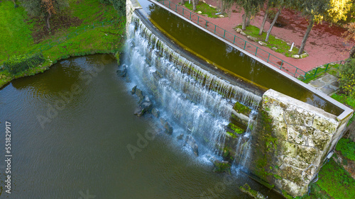 Fototapeta Naklejka Na Ścianę i Meble -  Aerial view at sunset on the waterfalls of the EUR lake park in Rome, Italy.