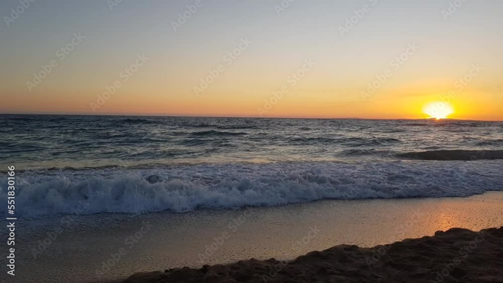 Sunset on the horizon over the Mediterranean Sea viewed from a sandy beach Sunset on the horizon over the Mediterranean Sea viewed from a sandy beach