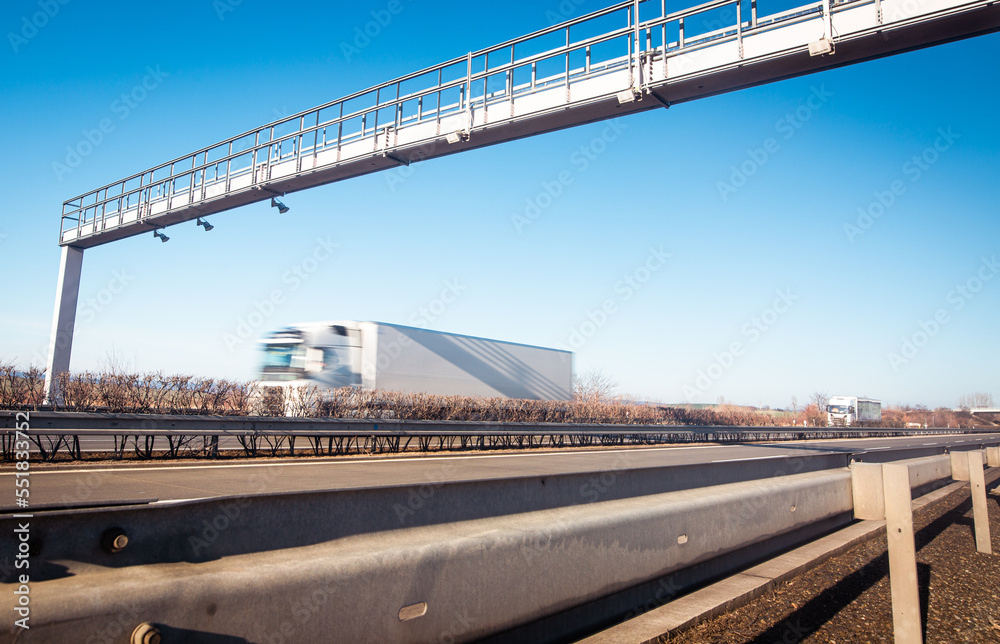 Trucks passing through the toll gate on highway, highway fee, industrial and transport concept