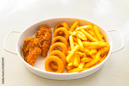 Fried Chicken breast hot crispy strips crunchy chicken tenders isolated on white background.Nuggets isolated on white background on a plate