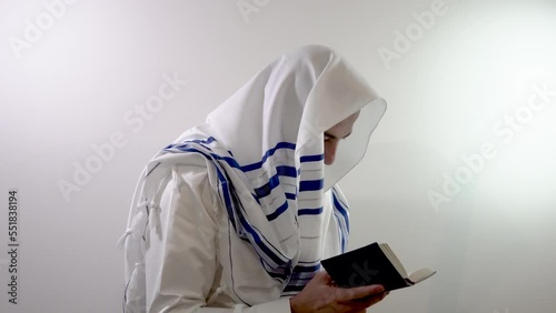 Religious jew in a tallit prays with a siddur in his hand. Judaism and jewish traditions (139)