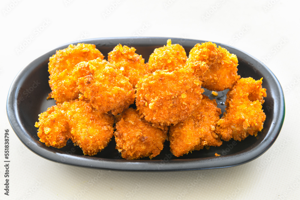 Fried Chicken breast hot crispy strips crunchy chicken tenders isolated on white background.Nuggets isolated on white background on a plate Fried Chicken breast hot crispy strips crunchy chicken tenders isolated on white background.Nuggets isolated on white background on a plate