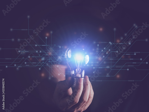 Businessman holding light bulb lighting with internet communication connection. Creativity, innovation and new invention and idea. Business design thinking and creativity innovation concept.