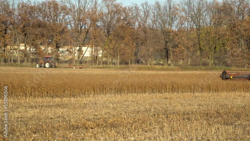 Harvesting machine working in the field. Combine harvester agricultural machine ride in the field of goldens soybean.