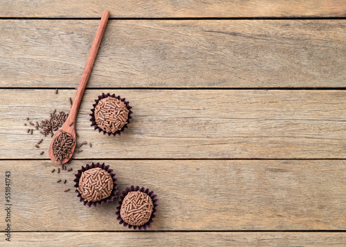 Typical brazilian chocolate brigadeiros over wooden table with copy space