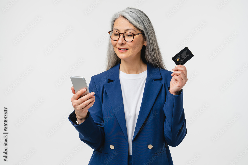 E-banking, e-commerce concept. Caucasian mature businesswoman bank manager employee using credit card for online shopping, paying domestic bills, receive payment, salary isolated in white background E-banking, e-commerce concept. Caucasian mature businesswoman bank manager employee using credit card for online shopping, paying domestic bills, receive payment, salary isolated in white background