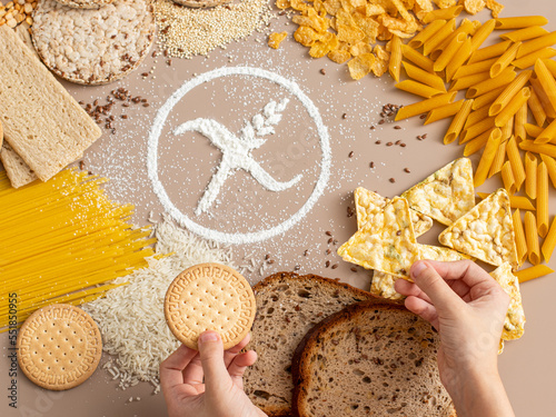 Gluten free food concept. Child hands holding gluten free snacks with symbol crossed sprinkle 