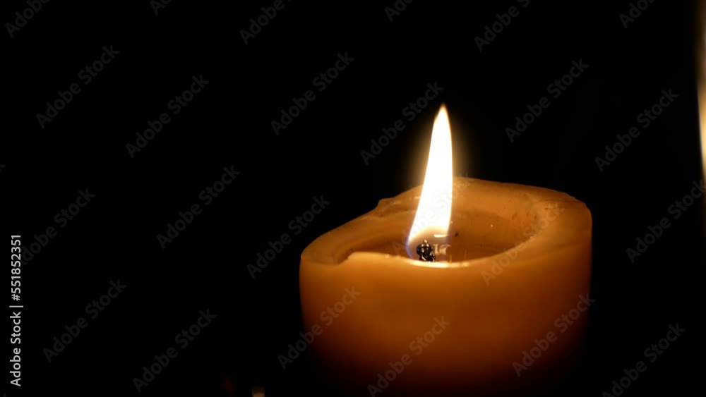 Burning candle flame with smoke on dark background. Mourning concept. Burning candle flame with smoke on dark background. Mourning concept.