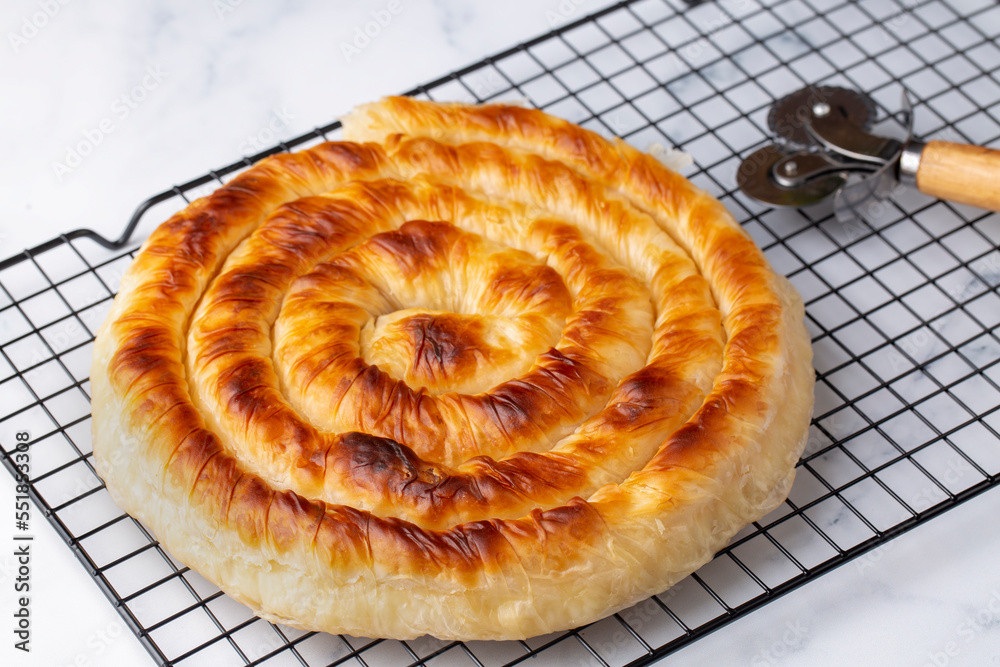 Traditional Turkish pastry with spinach. (Turkish Name: Ispanakli Kol Boregi, Bosnak boregi). Handmade pastry with spinach filling. Traditional Turkish pastry with spinach. (Turkish Name: Ispanakli Kol Boregi, Bosnak boregi). Handmade pastry with spinach filling.