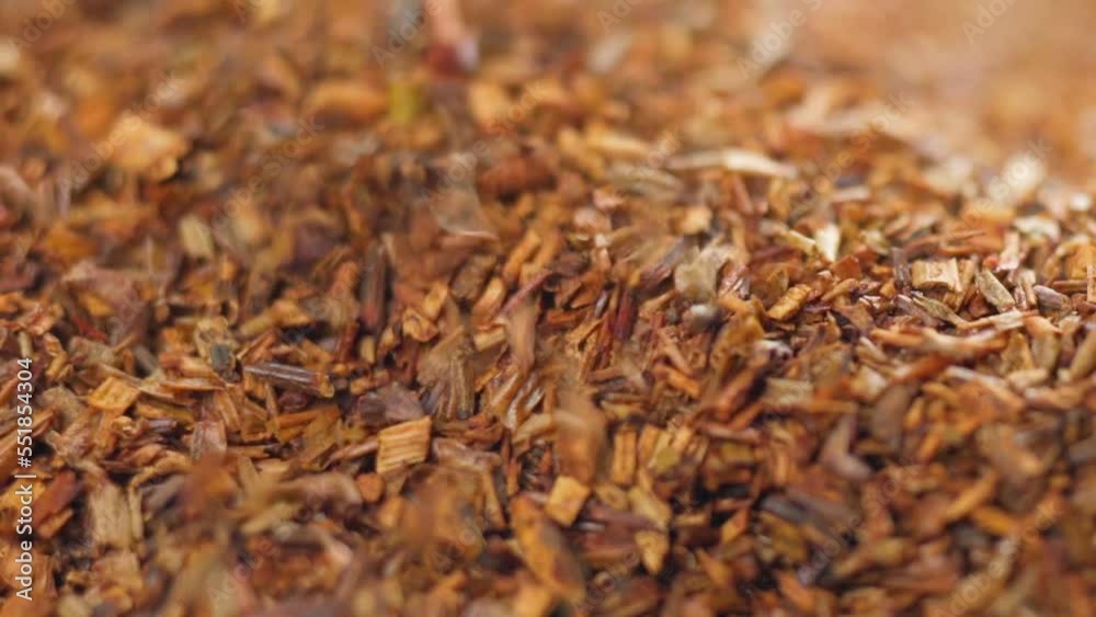 Tea drink rooibos made from the leaves, stems and flowers of a South African plant. Selective focus. Slow motion Tea drink rooibos made from the leaves, stems and flowers of a South African plant. Selective focus. Slow motion