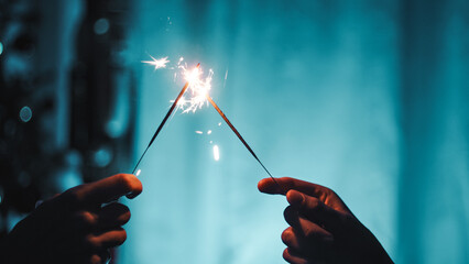 Sparklers on blue background. Happy new year,