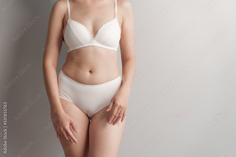 Close-up beauty asian woman in white bra and panties isolated over white background. Close-up beauty asian woman in white bra and panties isolated over white background.