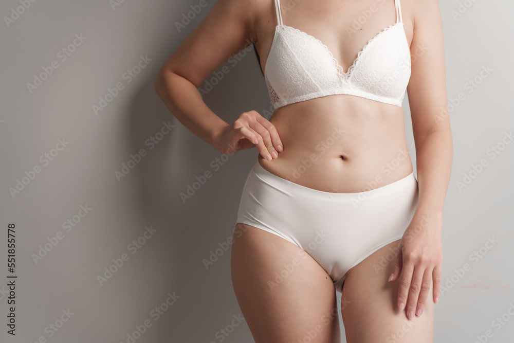 Close-up beauty asian woman in white bra and panties isolated over white background.