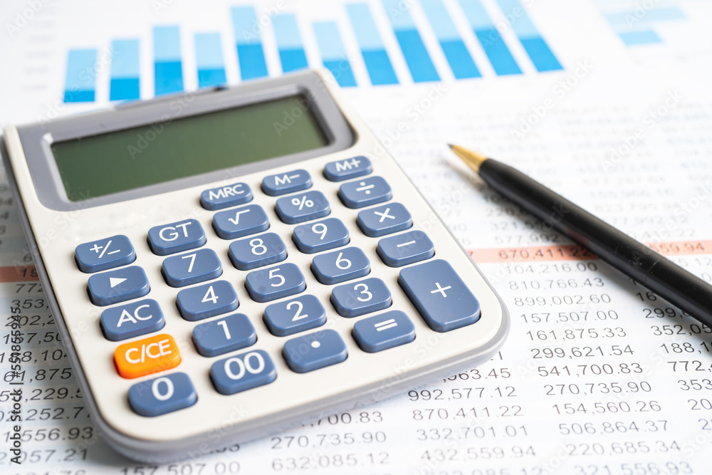 Magnifying glass on charts graphs spreadsheet paper with calculator. Financial development, Banking Account, Statistics, Investment Analytic research data economy. Magnifying glass on charts graphs spreadsheet paper with calculator. Financial development, Banking Account, Statistics, Investment Analytic research data economy.