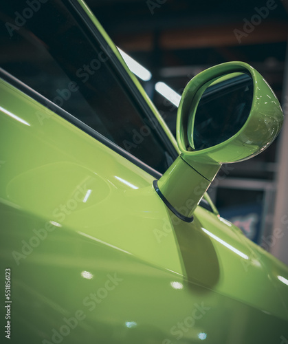 side rear-view mirror on a modern green car
