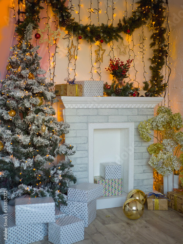 New Year's interior with a decorated Christmas tree and a fireplace. New Year's and Christmas