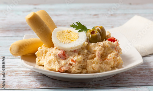 Russian salad. Typical Spanish tapa on a white plate.
