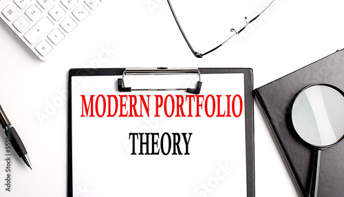 MPT MODERN PORTFOLIO THEORY text written on paper clipboard with office tools photo