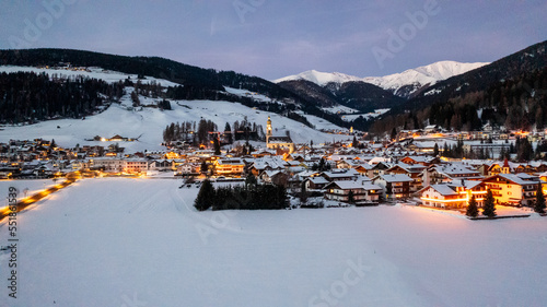 winter landscape, Dobbiaco Toblach, Bolzano, Italy. Aerial drone shot in january, Aerial view of beautiful alpin mountain town, christmas time , city with lights