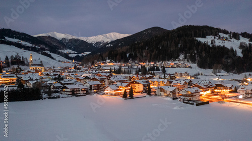 winter landscape, Dobbiaco Toblach, Bolzano, Italy. Aerial drone shot in january, Aerial view of beautiful alpin mountain town, christmas time , city with lights
