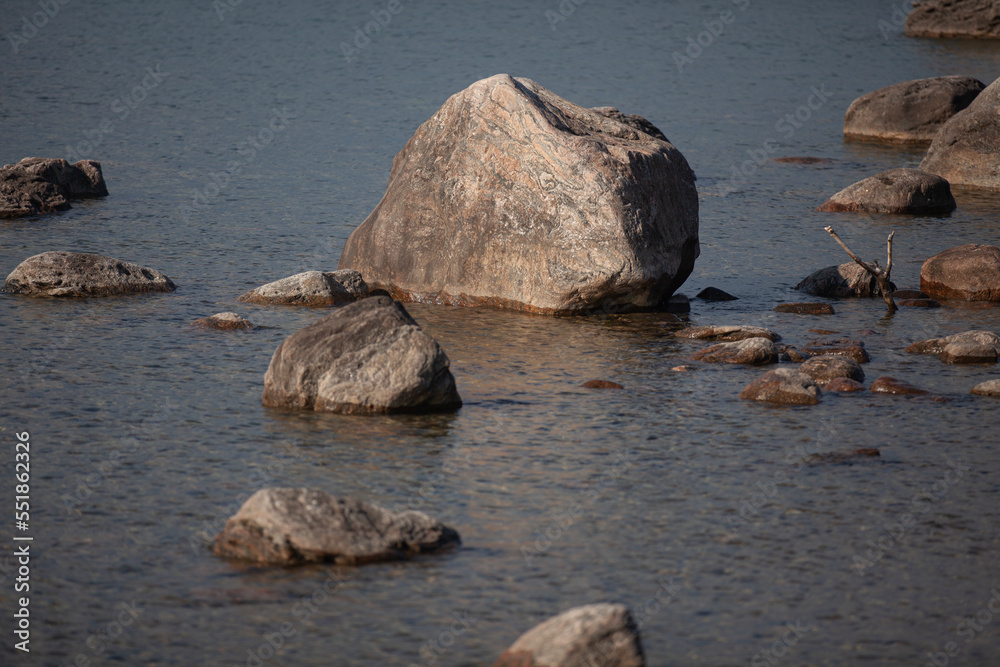 Large rocks along the shore of the water. Large rocks along the shore of the water.