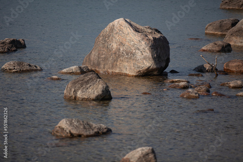Large rocks along the shore of the water.